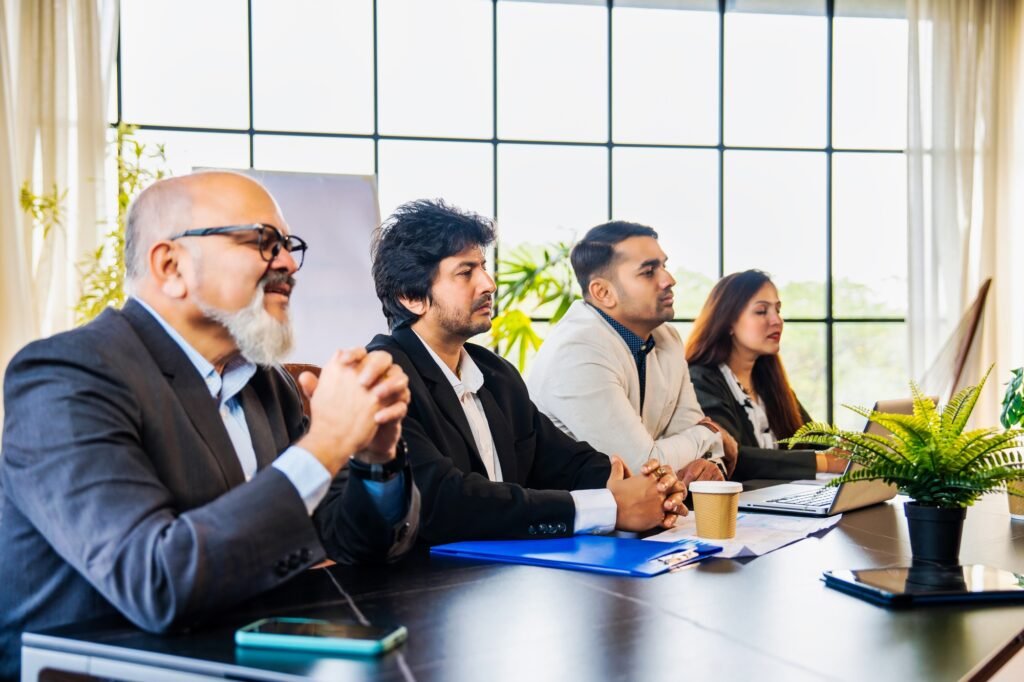 Indian Asian Corporate professionals engaged in a business interview or discussion across table